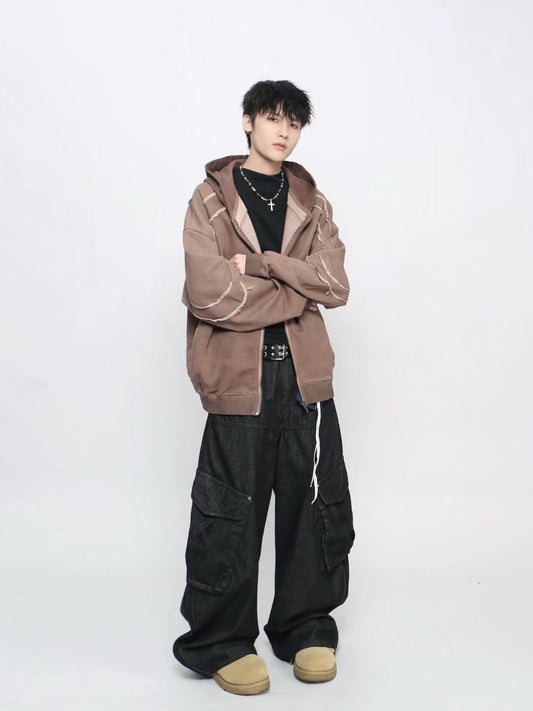 Person wearing a brown hoodie and black pants on a white background