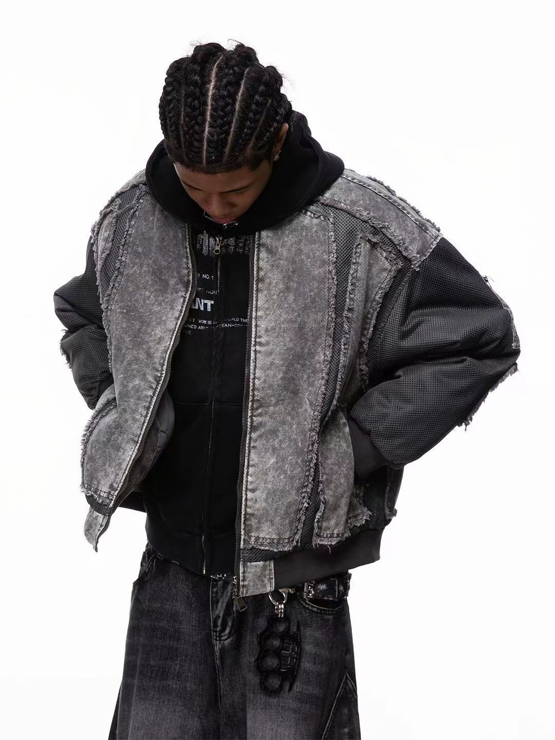 Person wearing a black and gray jacket with a white background